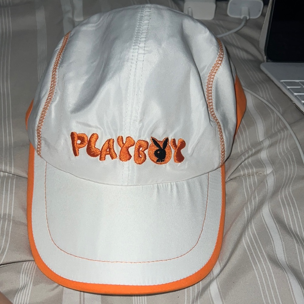 white and orange playboy hat